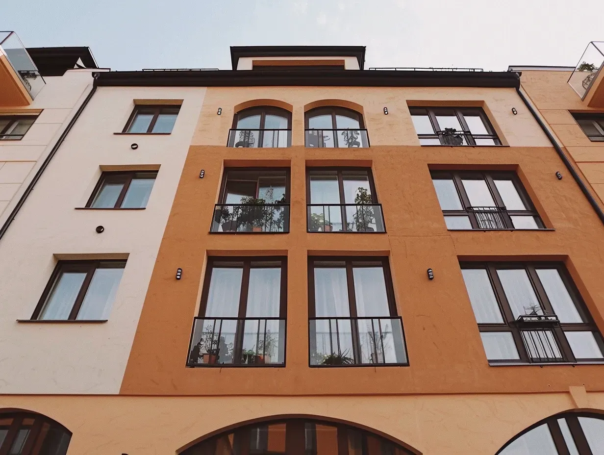 iqarat24_a_modern_apartment_building_with_large_windows_bal_2e71dcc0-8c0d-45bb-869a-8b1d373a590f_2_2